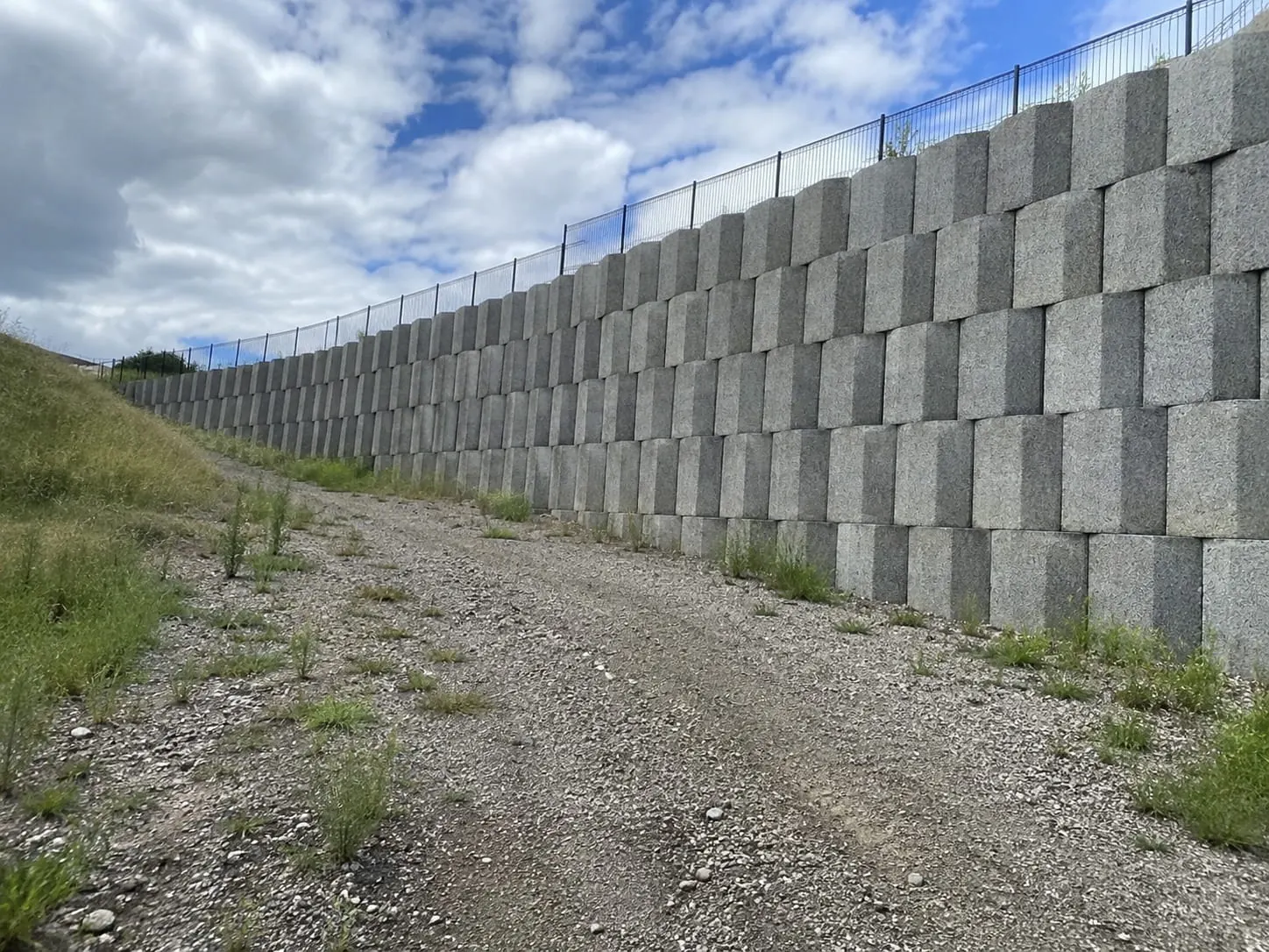 Interlocking segmental block retaining wall running the length of an Auckland site