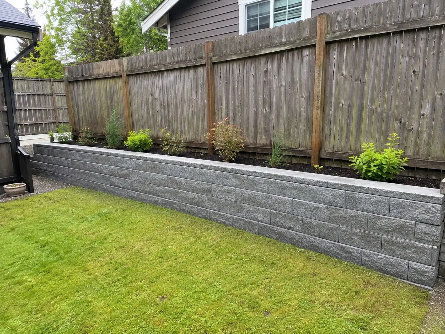 Besser block retaining wall specialists laying reinforced masonry