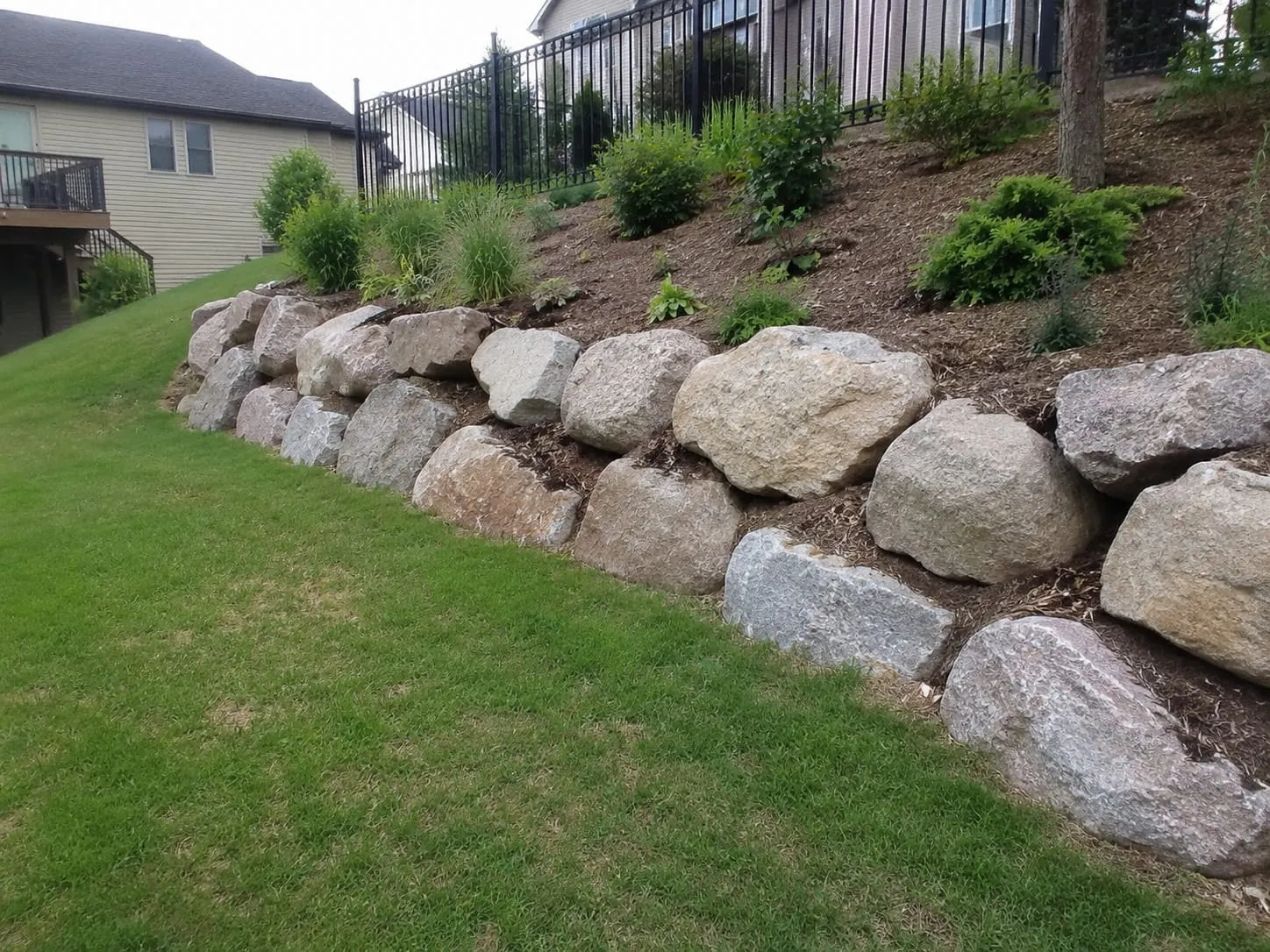 Natural boulder retaining wall in New Zealand