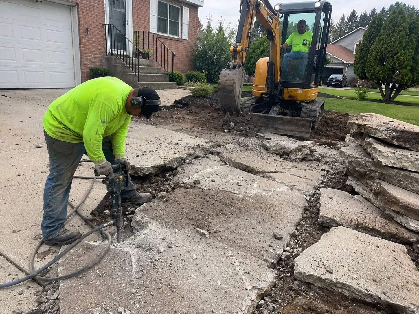 Concrete removal contractors breaking out a slab in Auckland