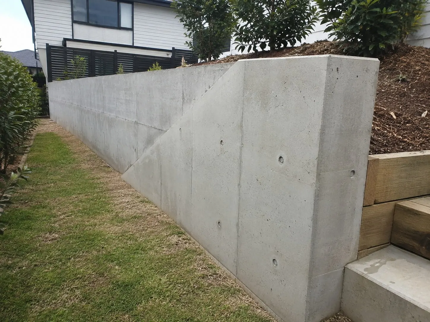 Poured concrete retaining wall on a steep Auckland section