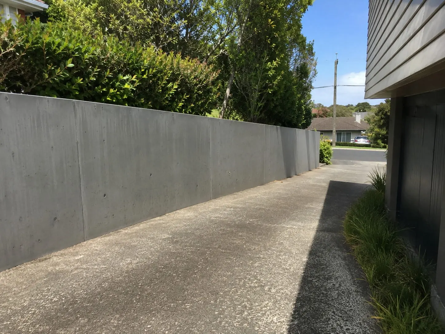 Poured concrete retaining wall on soft clay ground in Papakura, South Auckland